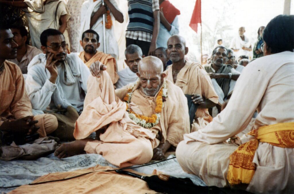 Srila Bhakti Bibudha Bodhayan Goswami Maharaj with his spiritual master, Srila Bhakti Pramod Puri Goswami Thakur, and other devotees. Festival time. Sankirtan