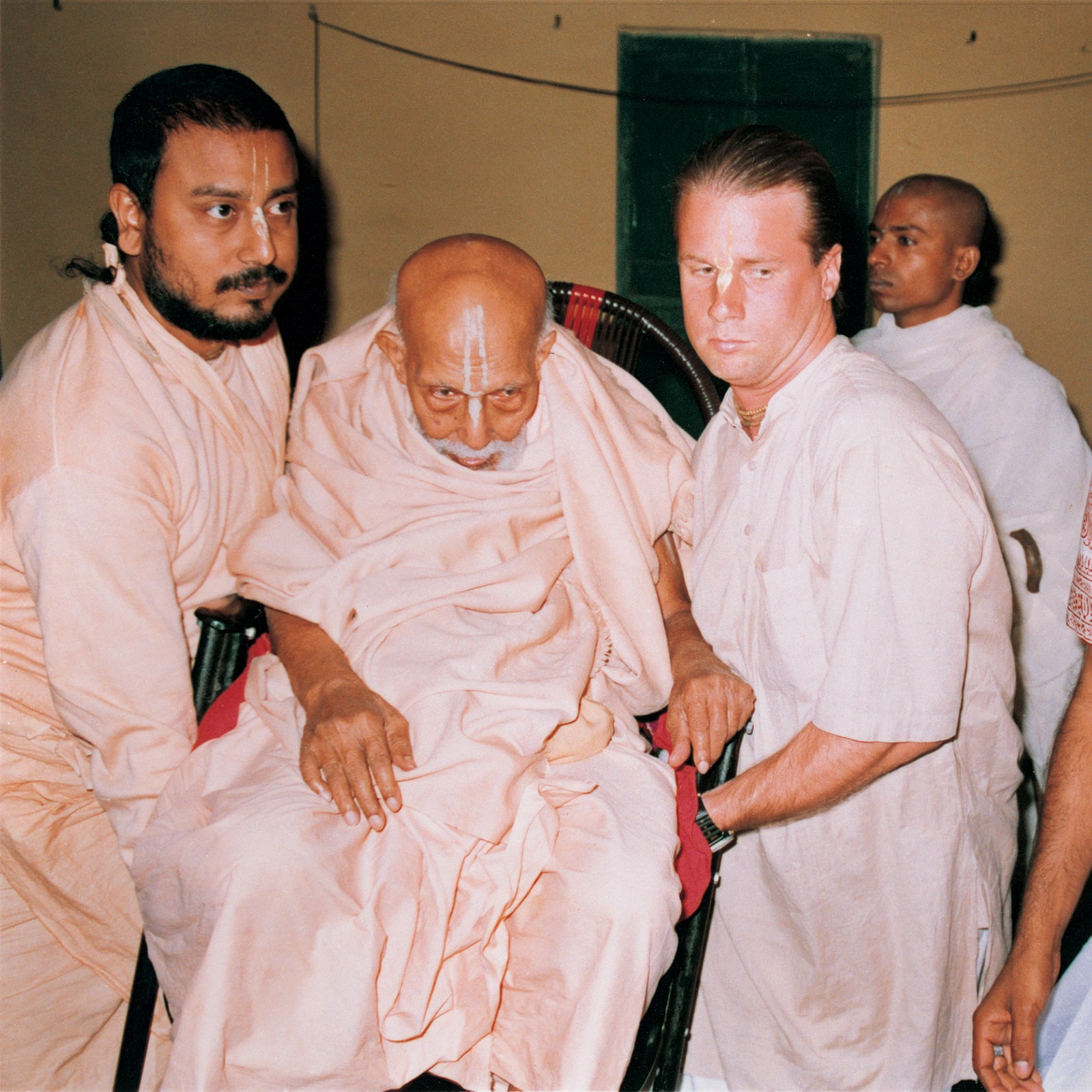 Srila Bhakti Bibudha Bodhayan Goswami Maharaj carrying Srila Bhakti Pramod Puri Goswami Thakur